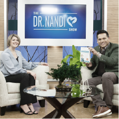 Dr. Myers sitting on the set of Dr. Nandi