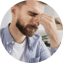Man with headache holding nose bridge