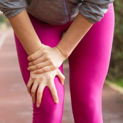 woman clutching knee