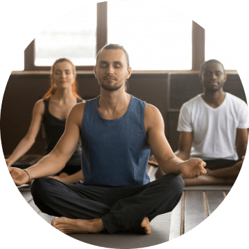 Three people mediating/doing yoga