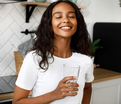 Woman feeling refreshed after drinking water